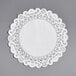 A white paper Normandy lace doily with a white border.