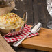 A Walco stainless steel teaspoon in a bowl of mashed potatoes on a table.