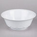 A white Thunder Group melamine bowl with a scalloped edge on a gray surface.