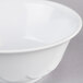 A white Thunder Group melamine bowl with a white scalloped rim.