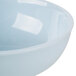 A light blue Thunder Group Blue Jade melamine bowl with a white rim.