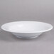 A white Thunder Group melamine salad bowl with a wide rim on a gray surface.