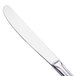 A close-up of a Walco stainless steel dinner knife with a white handle.