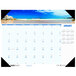 A House of Doolittle desk pad calendar with a beach and rocks on it.