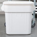 A Continental white plastic ingredient bin on wheels.