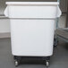 A Continental white plastic ingredient bin with wheels.