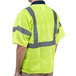 A man wearing a Cordova lime high visibility safety vest with reflective stripes.