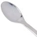 A close-up of a Fineline silver plastic tasting spoon.