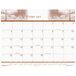 A House of Doolittle desk pad calendar with a nature scene of trees and snow.