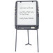 A charcoal Iceberg portable flipchart easel with writing on a white board.