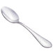 A close-up of a Walco stainless steel spoon with a textured silver handle.