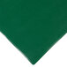 A green vinyl rectangle placemat on a table.