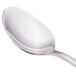 A Walco Freya stainless steel demitasse spoon with a silver handle.