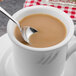 A Walco Freya demitasse spoon in a cup of coffee.