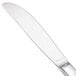 A close-up of a Walco stainless steel butter knife with a solid silver handle.