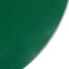 A close up of a green vinyl round placemat.