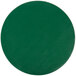 A green vinyl round placemat with a white circle.