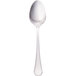 A Walco stainless steel serving spoon with a silver handle on a white background.