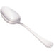 A close-up of a Walco stainless steel serving spoon with a silver handle.