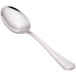 A close-up of a Walco Prim stainless steel teaspoon with a silver handle.