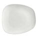 An Acopa Nova cream white stoneware plate with an asymmetric edge.