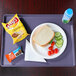 A Cambro dietary tray with a plate of food and a drink, including a sandwich and a bottle of water.