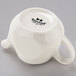 A Tuxton eggshell white china teapot with a handle.