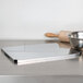 A stainless steel Matfer Bourgeat mousse sheet on a counter.