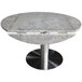 A round Art Marble table top with a metal base.