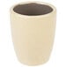 A white stoneware espresso cup with a brown inside.