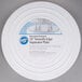 A white plastic Wilton cake separator plate with a label on it.