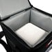 A black Sterno insulated food carrier bag holding a white foam container.