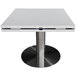 A white quartz table top with a round and drop leaf shape on a metal base.