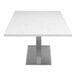 A white Art Marble Furniture Carrera White Quartz table top on a metal table base.
