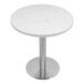 A white circular Art Marble Furniture Carrera White Quartz table top on a silver table base.