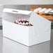 A white Quarter Sheet bakery box with a cupcake inside.