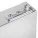 A close-up of an Avantco stainless steel reversible door with a latch.