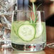 A Chef & Sommelier Sequence Rocks glass with cucumber slices in a drink.