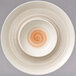A white porcelain plate with a white and orange spiral design.