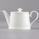 A Villeroy & Boch white bone porcelain teapot with a lid and a handle.