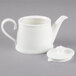 A close-up of a Villeroy & Boch white bone porcelain teapot with a lid.