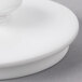 The lid of a white Villeroy & Boch porcelain teapot.