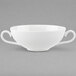 A white Villeroy & Boch bone porcelain bouillon cup with two handles on a gray surface.