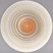 A taupe porcelain plate with a white background and brown swirls.