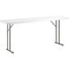 A white rectangular Lancaster Table & Seating heavy-duty plastic table with metal legs.
