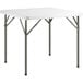 A white square Lancaster Table & Seating folding table with metal legs.