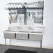 A large silver Metro SmartWall G3 dish washing station with utensils above a sink.