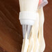 A person using an Ateco St. Honore medium piping tip with a white frosting bag.