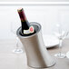 A bottle of wine in a stainless steel wine cooler.