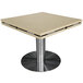 An Art Marble Furniture Cambrian Gold quartz table top with drop leaf extensions on a table with a metal base.